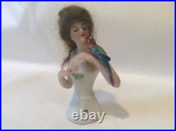 4 German bisque half doll. Wigged lady with parrot