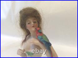 4 German bisque half doll. Wigged lady with parrot