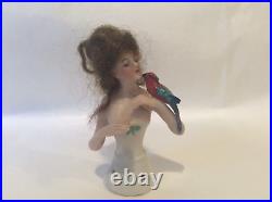 4 German bisque half doll. Wigged lady with parrot