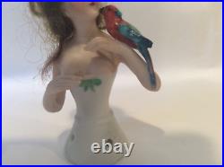 4 German bisque half doll. Wigged lady with parrot