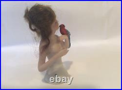 4 German bisque half doll. Wigged lady with parrot