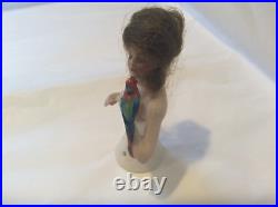 4 German bisque half doll. Wigged lady with parrot