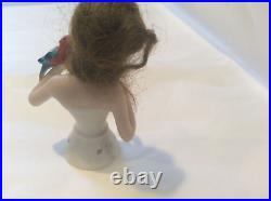 4 German bisque half doll. Wigged lady with parrot