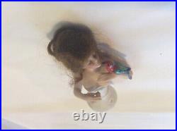 4 German bisque half doll. Wigged lady with parrot