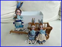 Antique doll set with 3 dolls and a handcart