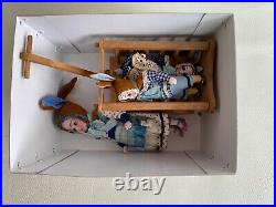 Antique doll set with 3 dolls and a handcart
