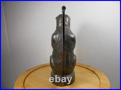 Antique vintage German metal chocolate mold with clamps sitting bear on tree trunk