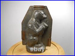 Antique vintage German metal chocolate mold with clamps sitting bear on tree trunk