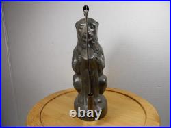 Antique vintage German metal chocolate mold with clamps sitting bear on tree trunk