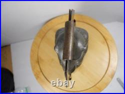 Antique vintage German metal chocolate mold with clamps sitting bear on tree trunk