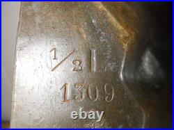 Antique vintage German metal chocolate mold with clamps sitting bear on tree trunk