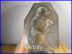 Antique vintage German metal chocolate mold with clamps sitting bear on tree trunk