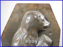 Antique vintage German metal chocolate mold with clamps sitting bear on tree trunk