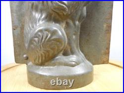 Antique vintage German metal chocolate mold with clamps sitting bear on tree trunk