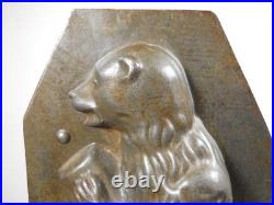 Antique vintage German metal chocolate mold with clamps sitting bear on tree trunk