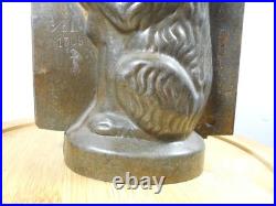 Antique vintage German metal chocolate mold with clamps sitting bear on tree trunk