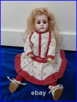 Beautiful antique doll with lovely dolldress