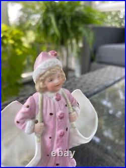 Heubach Rare Little girl in winter/pink coat carrying side pockets. Vintage
